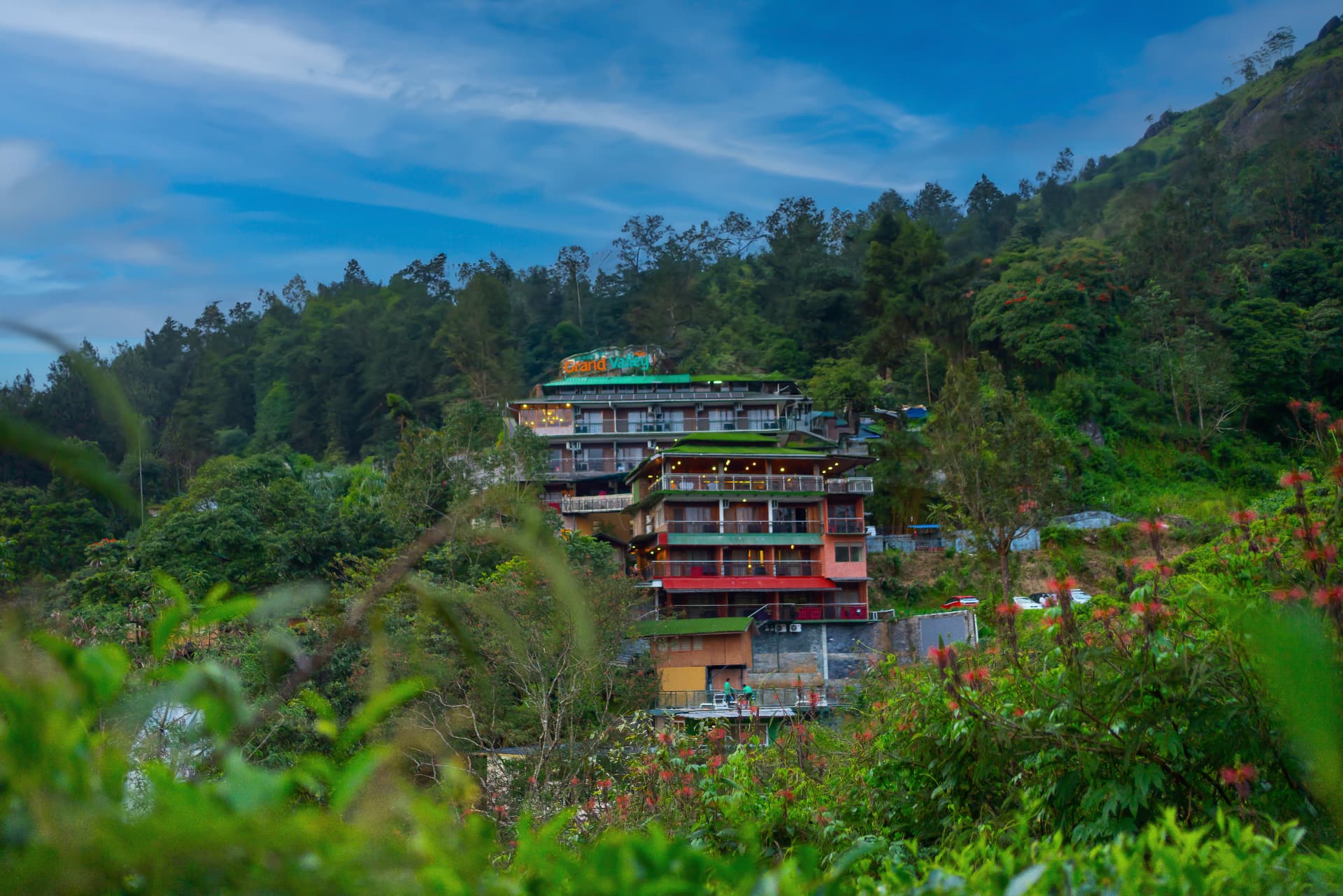 Grand Valley Resort, Munnar, lit at blue hour with the valley darkening below